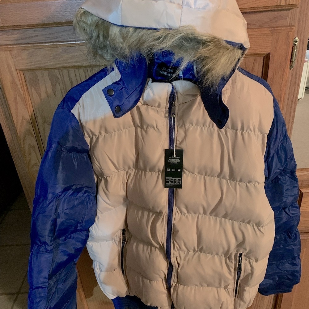 Coat with furry hood.  Color is beige with royal blue sleeves.